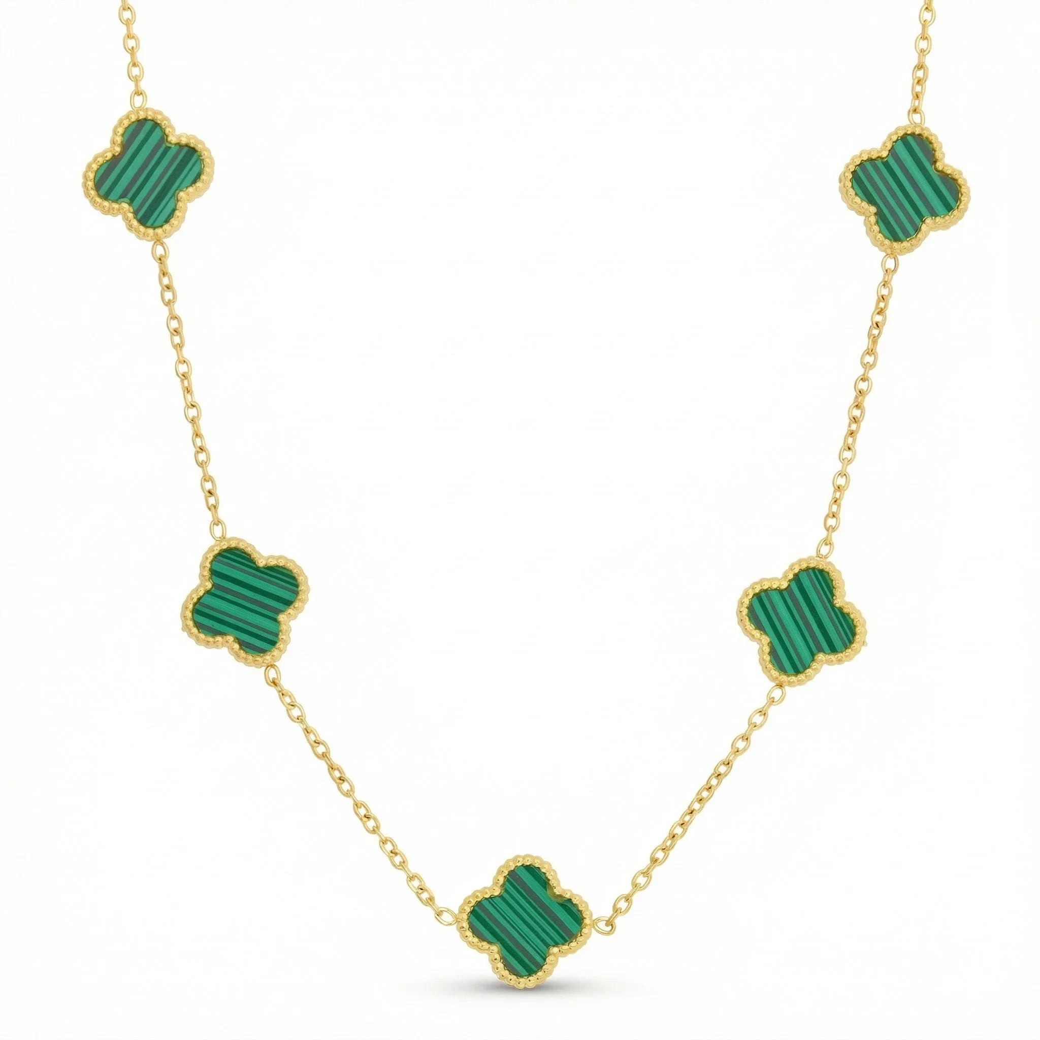 Gold necklace with green clover-shaped charms and beaded edges on a white background