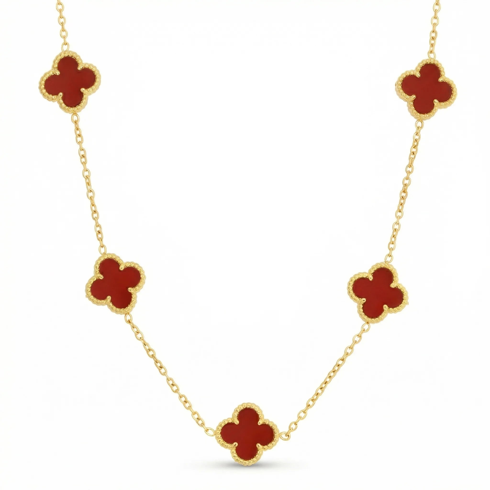 Gold necklace with red clover-shaped charms, elegant jewelry on white background