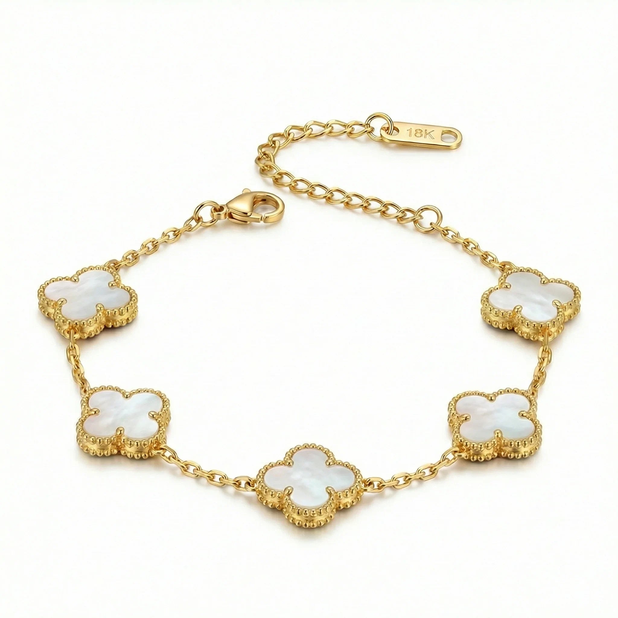 18k gold bracelet with mother-of-pearl clover charms on a white background