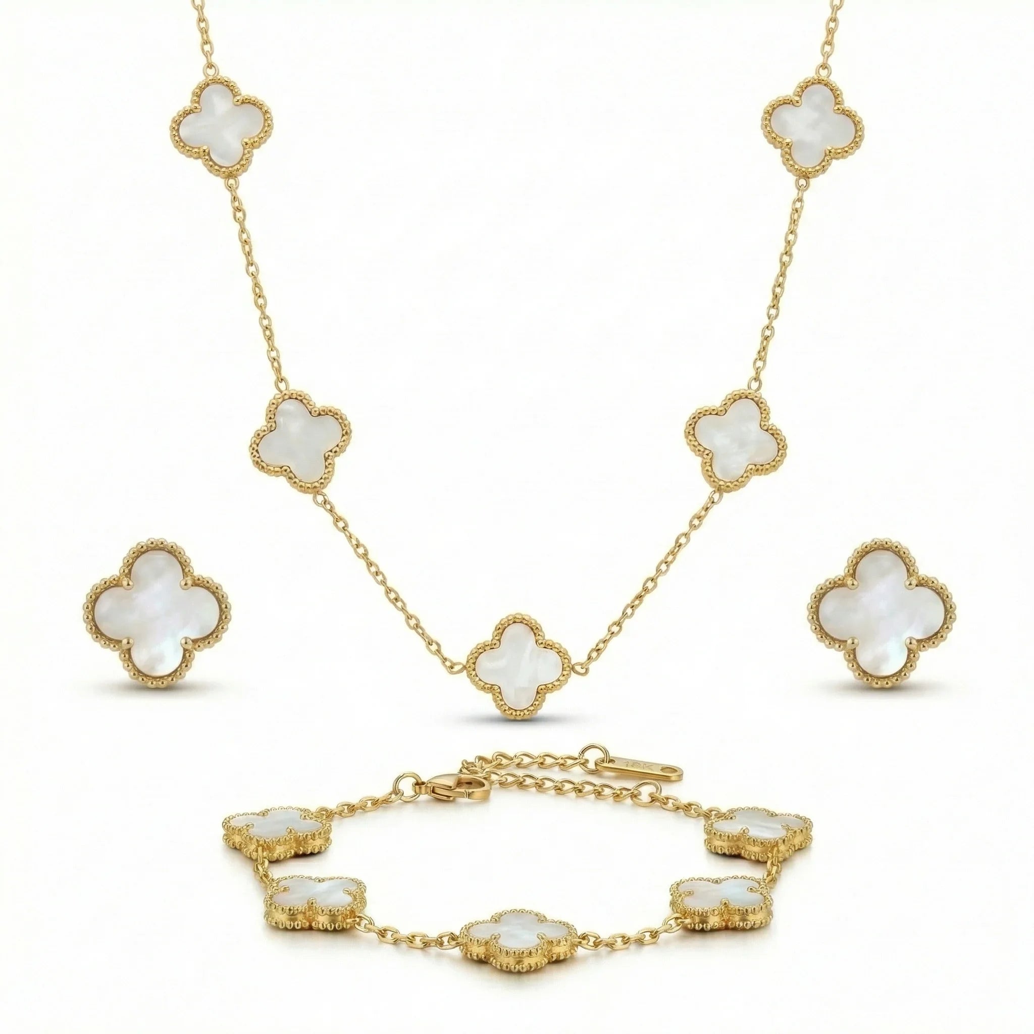Gold jewelry set with mother-of-pearl clover necklace, bracelet, and stud earrings on white background